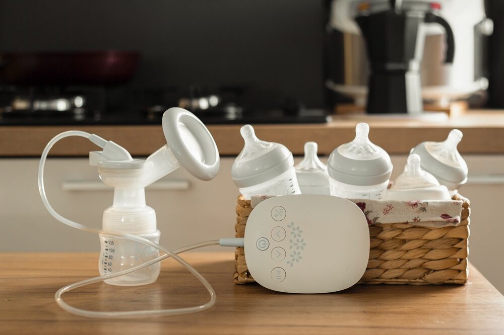 Breast milk pump and milk bottle inside a bucket